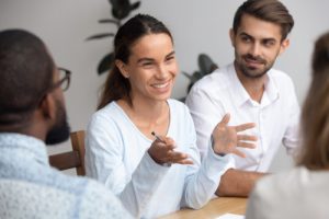 A web developer speaking to happy clients