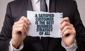 Satisfied customers A web developer holding satisfied customers message