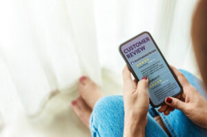Good reviews - person leaving a good review on a mobile device
