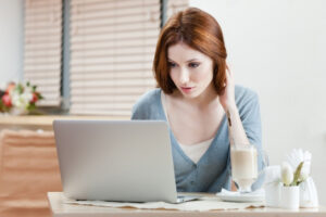 Lady writing a blog on laptop