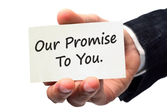 Male hand holding our promise to you card